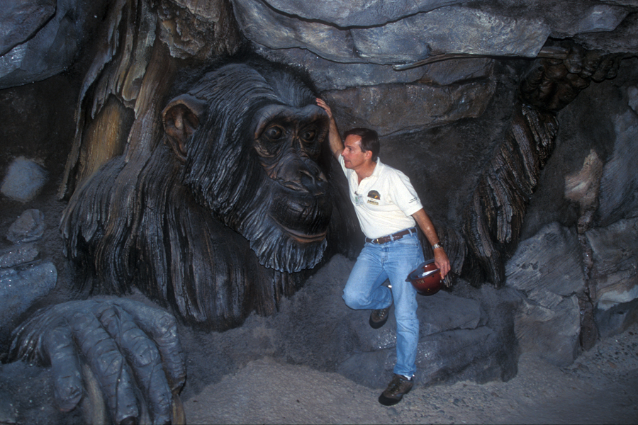 Rick Barongi in front of a chimpanzee sculpture especially dedicated to the work of Jane Goodall.