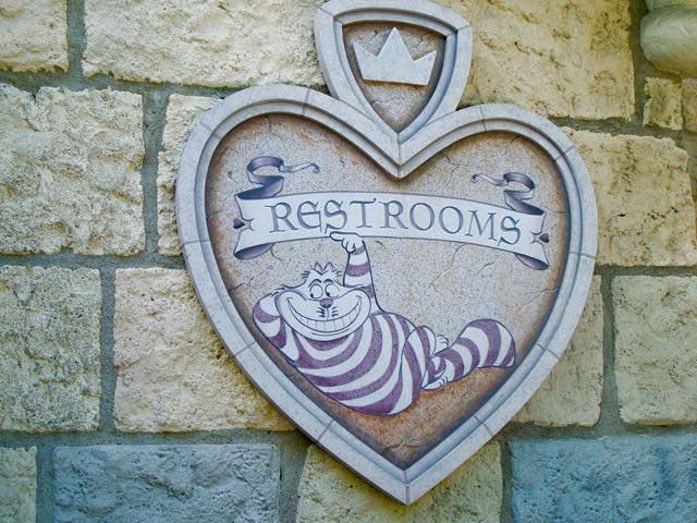 The Chesire Cat points this way to a uniquely themed set of restrooms at Disneyland tied to Alice in Wonderland. Here stall doors are like playing cards. Photo by J. Jeff Kober.