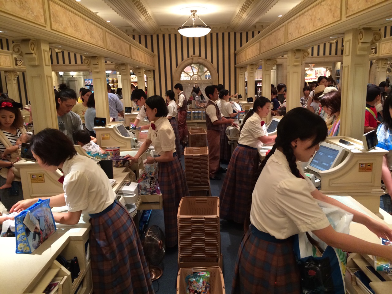 The same checkout concept in Tokyo Disneyland, also with a banking-style theme. Photo by J. Jeff Kober.